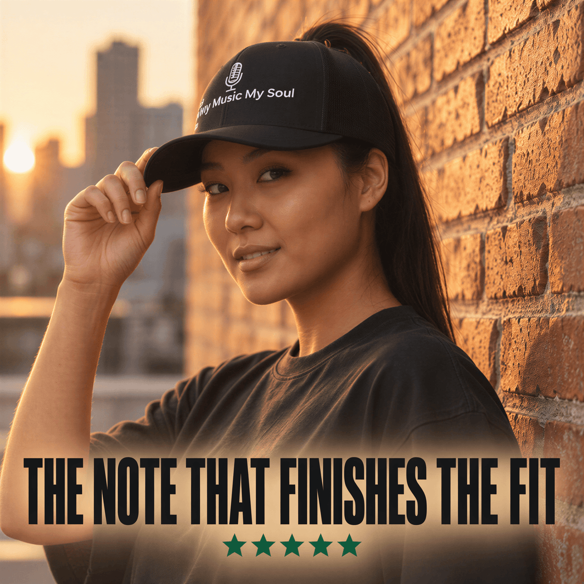 A woman wearing a black baseball cap with the embroidered white text 'My Music My Soul' and a microphone icon, posing against a warm brick wall at sunset. Large text at the bottom reads 'THE NOTE THAT FINISHES THE FIT' with five green stars below.
