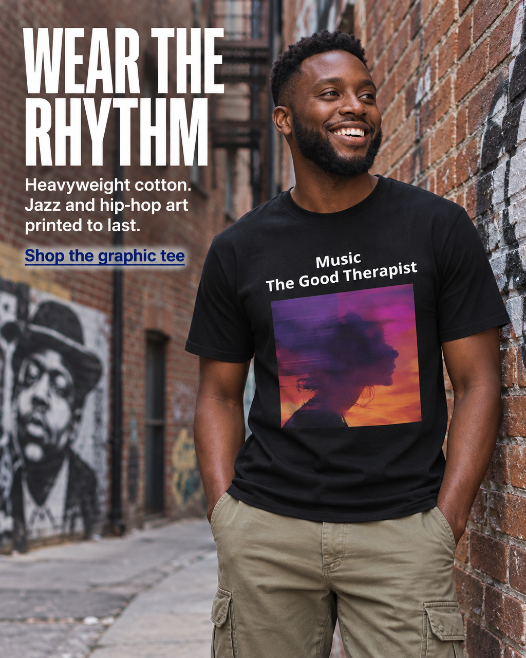 A smiling man stands in a brick alley wearing a black graphic T-shirt with the text 'Music The Good Therapist' above a colorful sunset silhouette print. Large promotional text on the left reads 'WEAR THE RHYTHM' with additional shirt details.